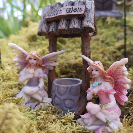 fairy figures and a wishing well